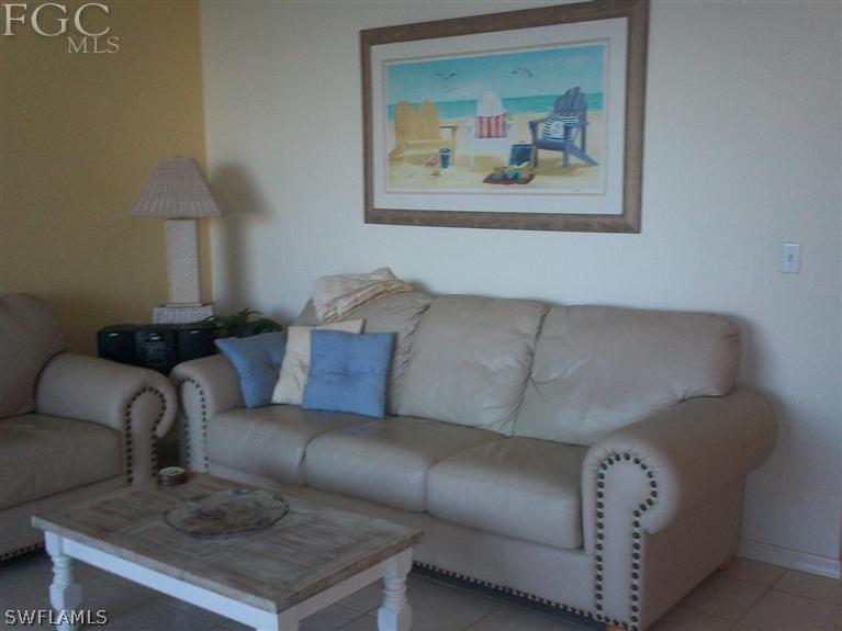 14111 Brant Point Circle, Unit 236 Fort Myers, FL 33919 - Photo 9 of 22 a living room with furniture and a painting