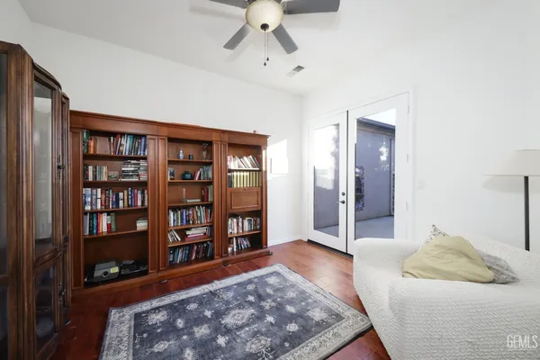 a bedroom with a large bed and a book shelf