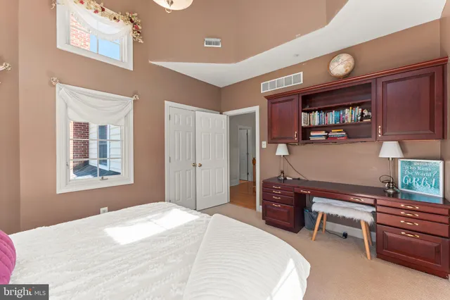 a spacious bedroom with a bed and a chandelier