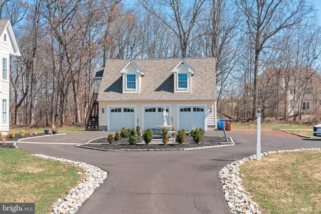 a front view of a house with a yard and a garden