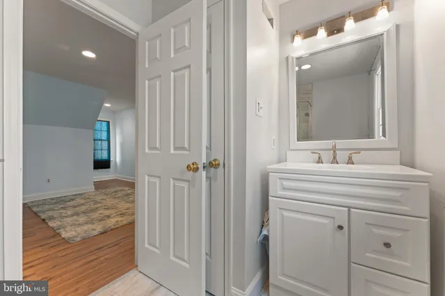 a view of a large pool with wooden floor and fence next to a yard