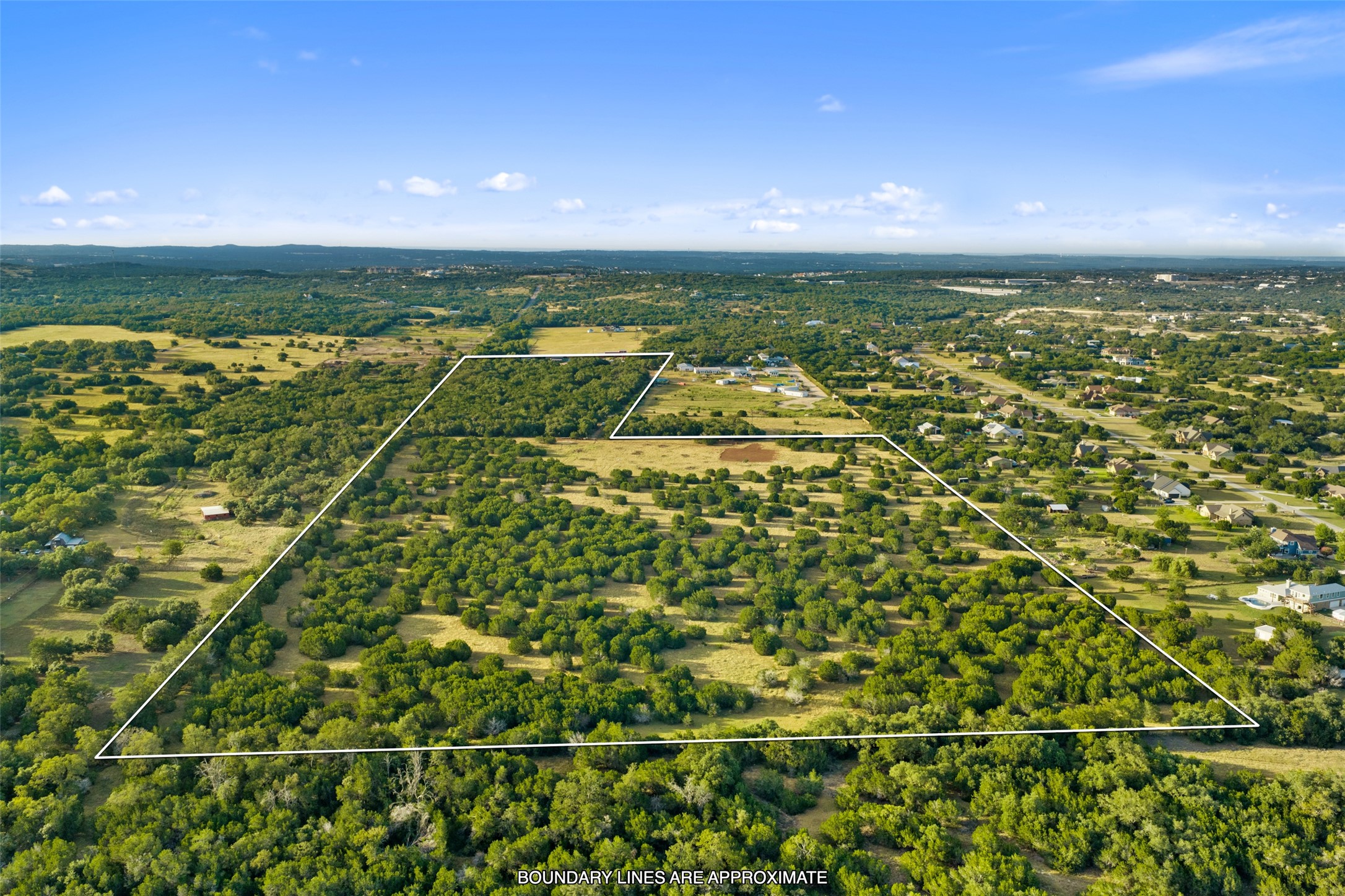 0 Hays Country Acres Road Dripping Springs, TX 78620 - Photo 3 of 33 An aerial perspective showcases the vast property lines nestled within a scenic, tree-filled landscape.