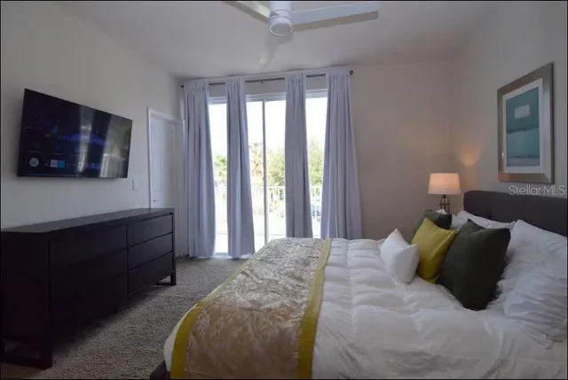 a bedroom with a bed and a flat screen tv