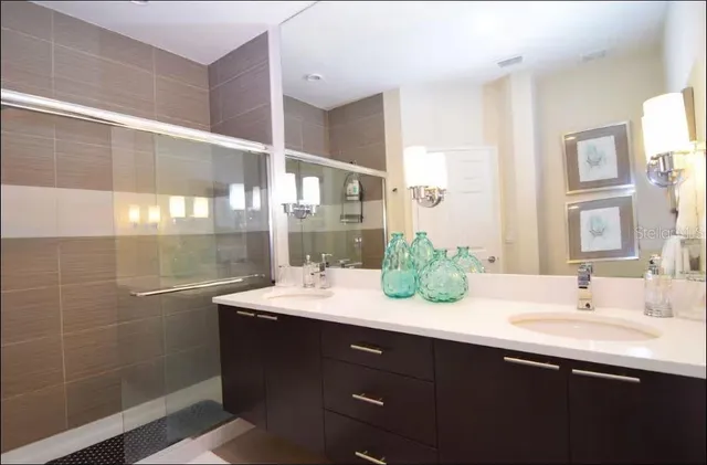 a bathroom with a double vanity sink mirror and double