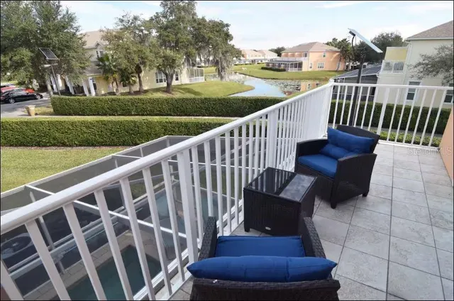 a view of a chair in a yard with wooden fence