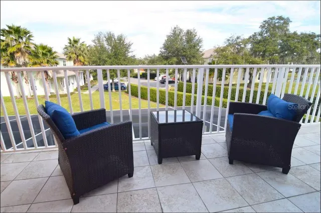 a roof deck with couches and wooden fence