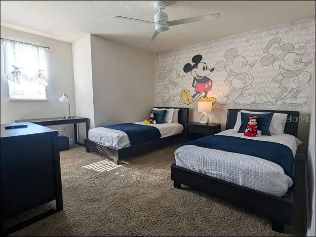 a bedroom with two beds and a chandelier