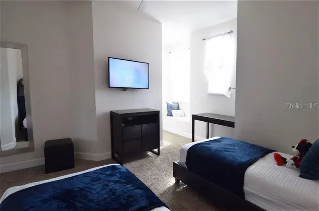 a bedroom with a bed and a couch