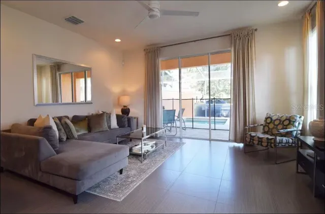 a living room with furniture and a large window