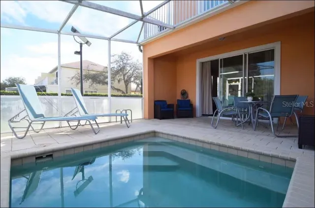 a view of a chairs and table in patio