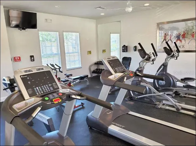 a room with gym equipment and a large window