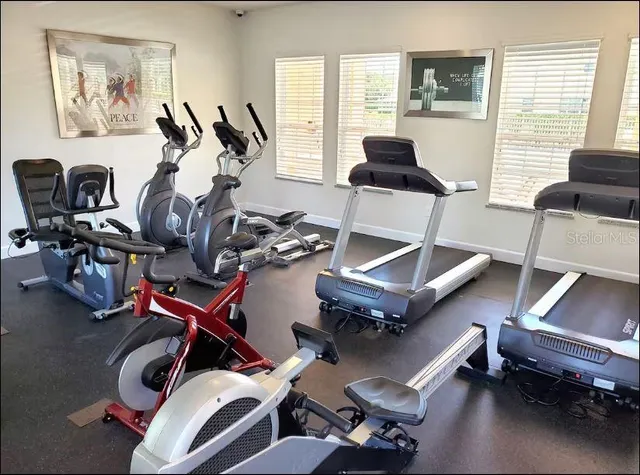 a living room with furniture and gym equipment