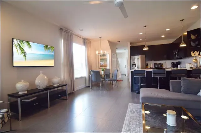 a living room with furniture and kitchen view