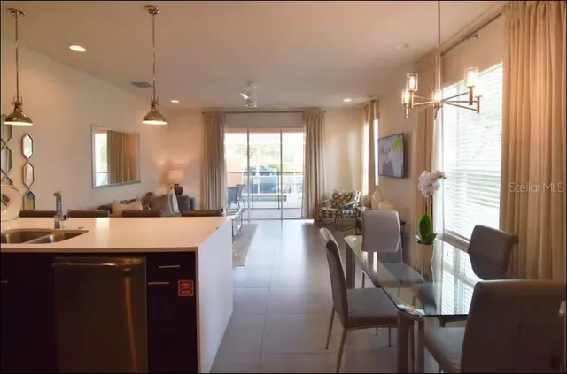 a large kitchen with a large window and stainless steel appliances