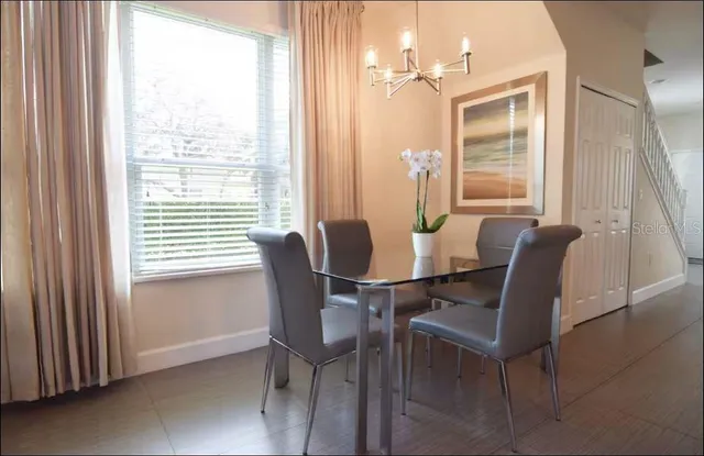 a view of a dining room with furniture and a window
