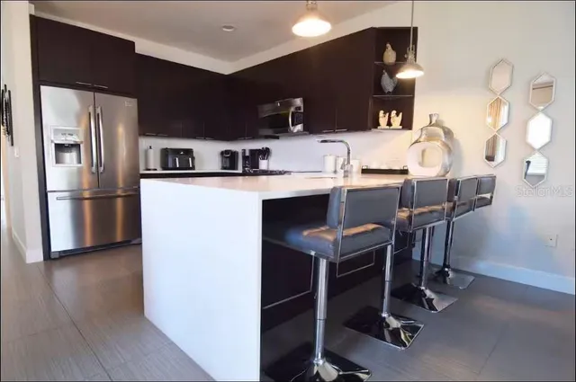 a kitchen with a sink appliances and cabinets