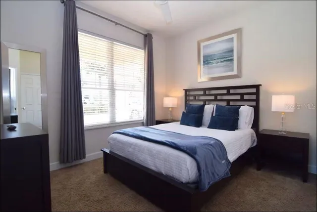 a bedroom with a bed and a window