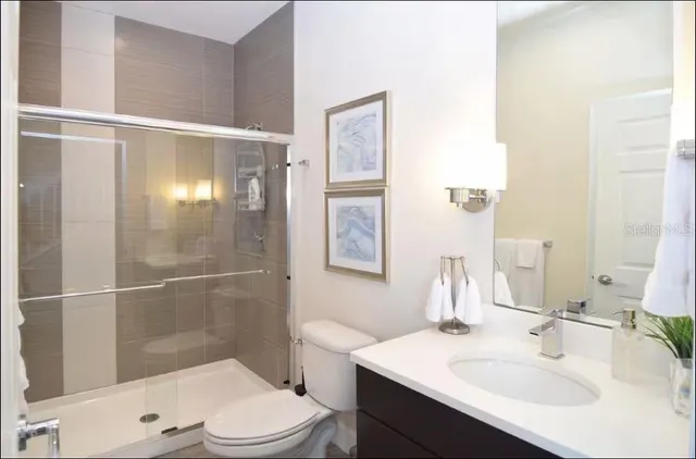 a bathroom with a sink toilet and shower