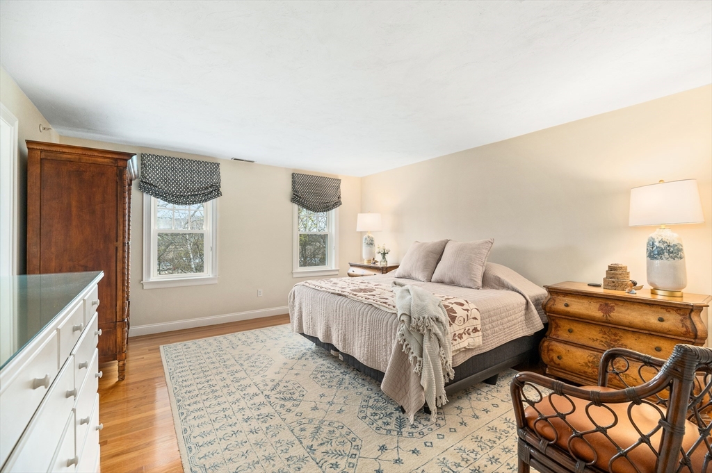6 Essex Road, Unit 8 Ipswich, MA 01938 - Photo 15 of 35 a bedroom with a bed and wooden floor
