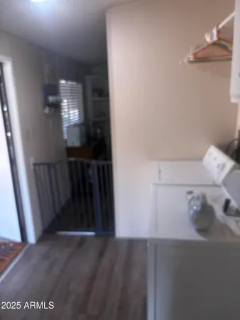 a kitchen with a table chairs a sink dishwasher and cabinets