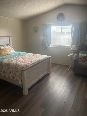 a bed sitting in a bedroom next to a window
