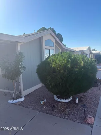 a view of a house with a yard and potted plants