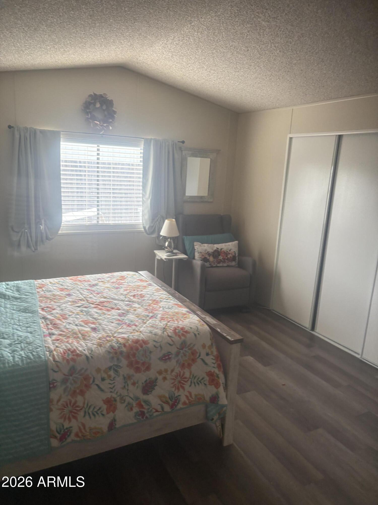 3330 East Main Street, Unit 409 Mesa, AZ 85213 - Photo 32 of 36 a bedroom with a bed and a window