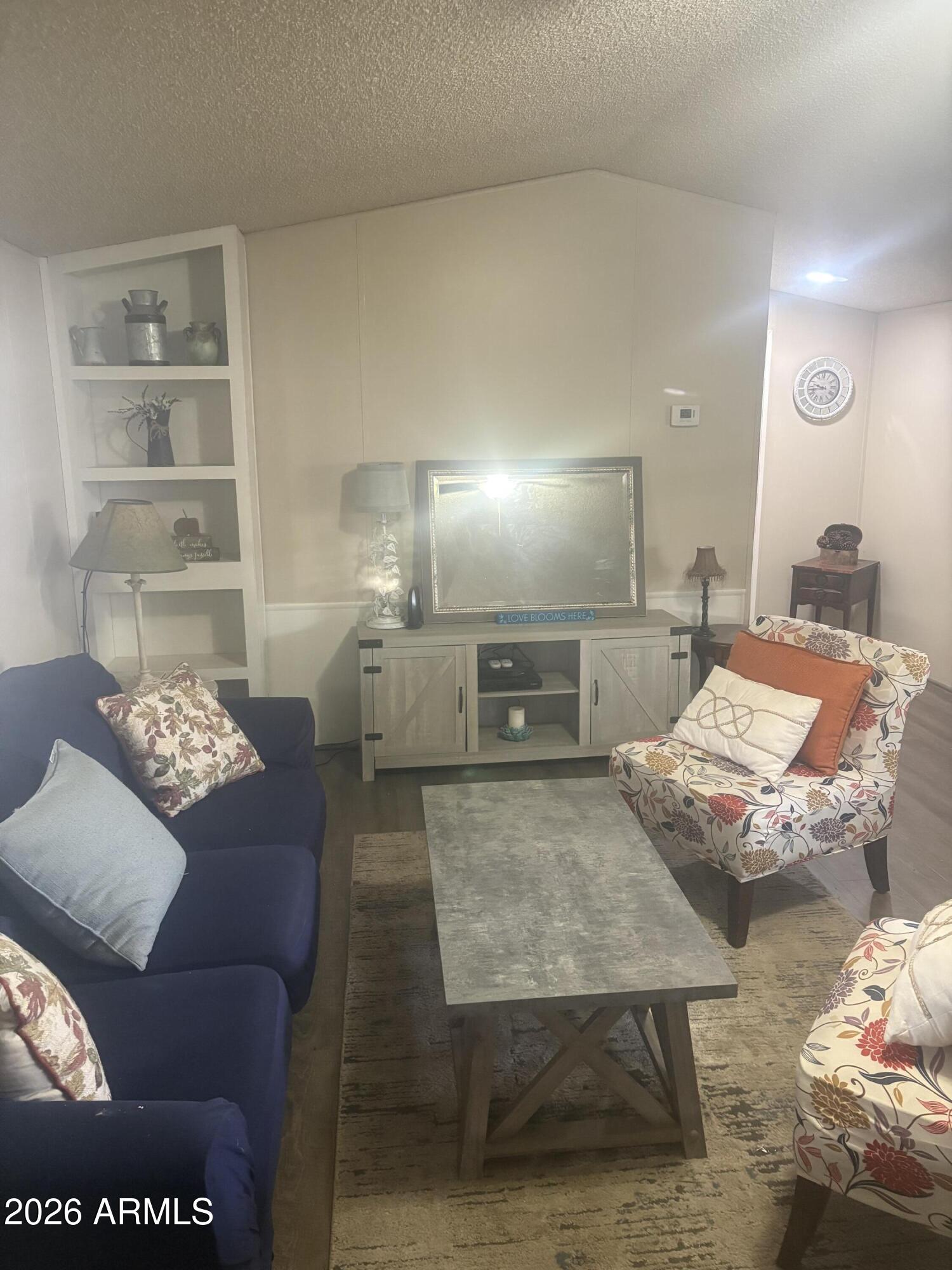 3330 East Main Street, Unit 409 Mesa, AZ 85213 - Photo 35 of 36 a living room with furniture and a table