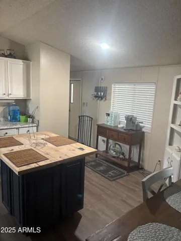 a room with a table chairs and wooden floor