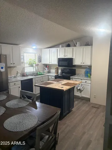 a kitchen with a sink appliances and cabinets