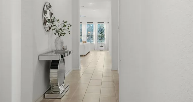 a living room with furniture a table and chairs