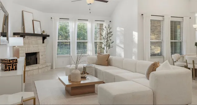 a living room with furniture and a chandelier