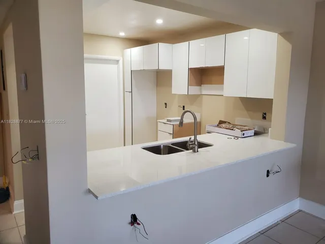 a kitchen with a sink a stove and refrigerator