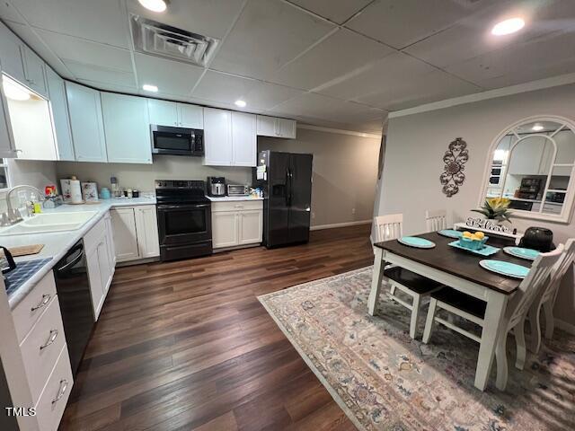 124 Don Ron Road Erwin, NC 28339 - Photo 16 of 67 a kitchen with stainless steel appliances kitchen island granite countertop a refrigerator a sink dishwasher a stove top oven a dining table and chairs with wooden floor