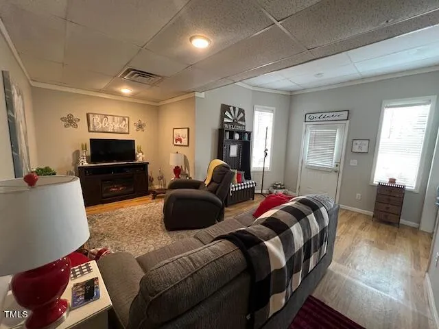 a living room with furniture fireplace and a window