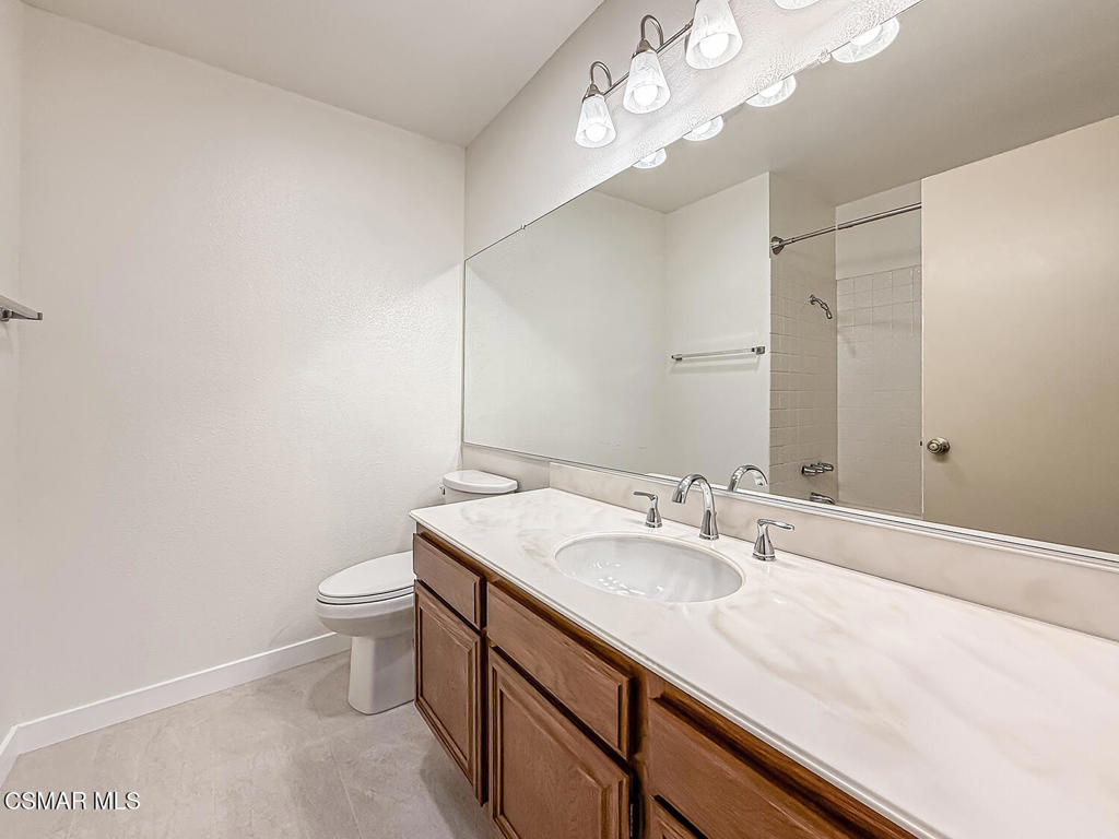 4007 Doneva Road Moorpark, CA 93021 - Photo 33 of 58 a bathroom with a sink a toilet and a large mirror