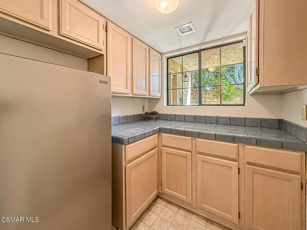 4007 Doneva Road Moorpark, CA 93021 - Photo 41 of 58 a kitchen with granite countertop white cabinets and white appliances