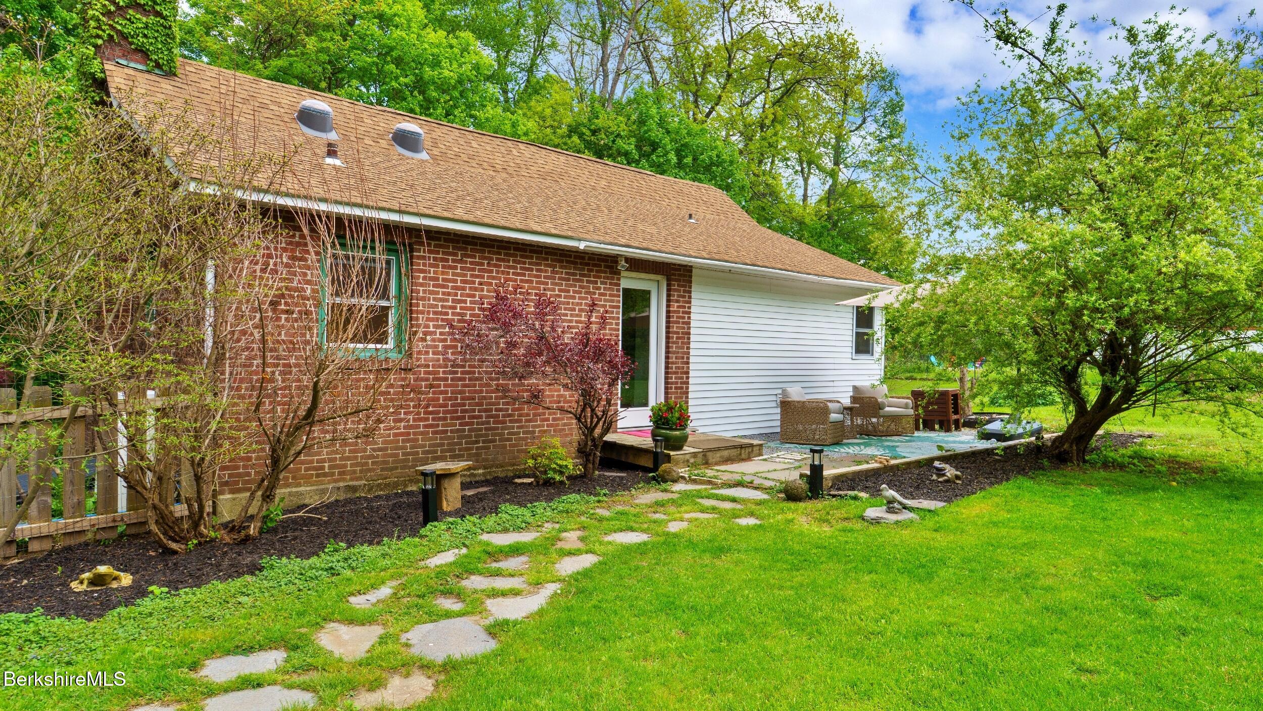 20 East Dugway Road Lenox, MA 01240 - Photo 52 of 84 a backyard of a house with table and chairs
