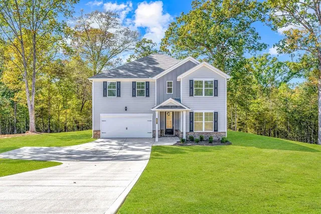 a front view of house with yard and green space