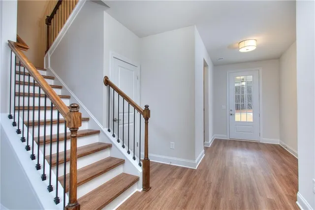 a view of an entryway with wooden floor
