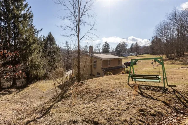 a view of yard with wooden fence