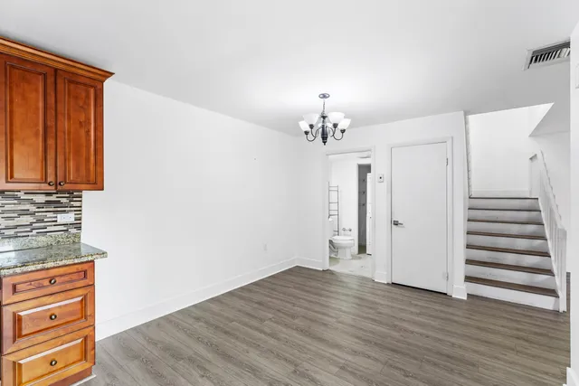 wooden floor in an empty room with a mirror