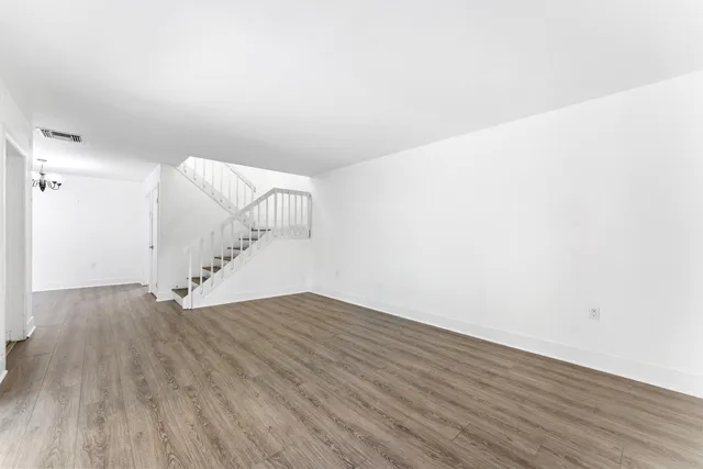 a view of entryway and hall with wooden floor