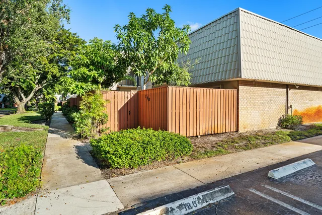 a view of a house with a yard and street