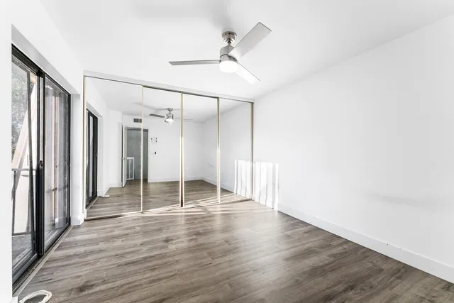 a view of a backyard with potted plants and wooden fence