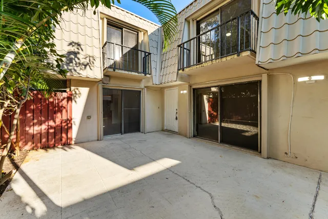 a view of a house with a backyard and plants