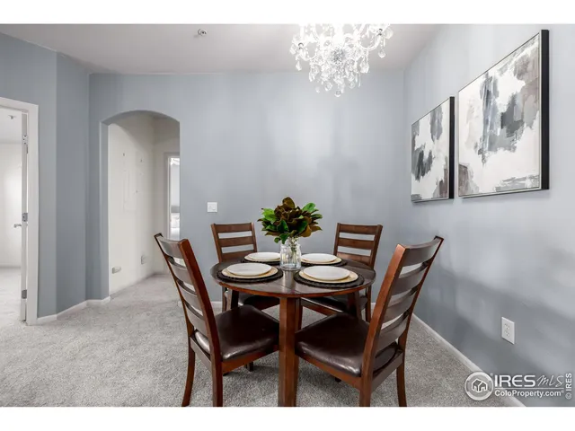 a view of a building with backyard and sitting area