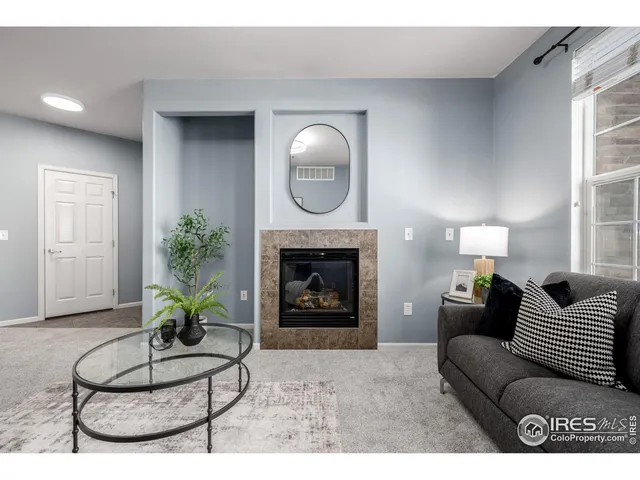 a kitchen with stainless steel appliances granite countertop a refrigerator a stove a sink and a dining table with white cabinets