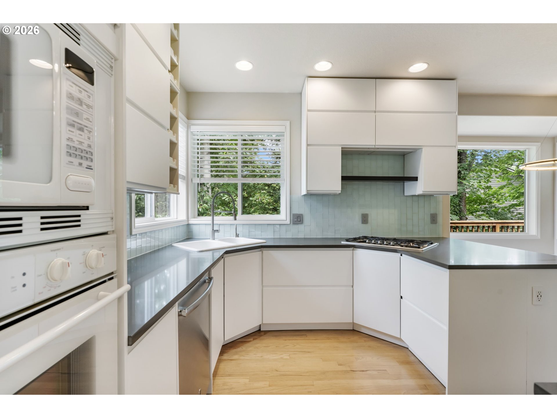 9907 Northwest Bartholomew Drive Portland, OR 97229 - Photo 13 of 37 a kitchen with stainless steel appliances a sink stove and cabinets