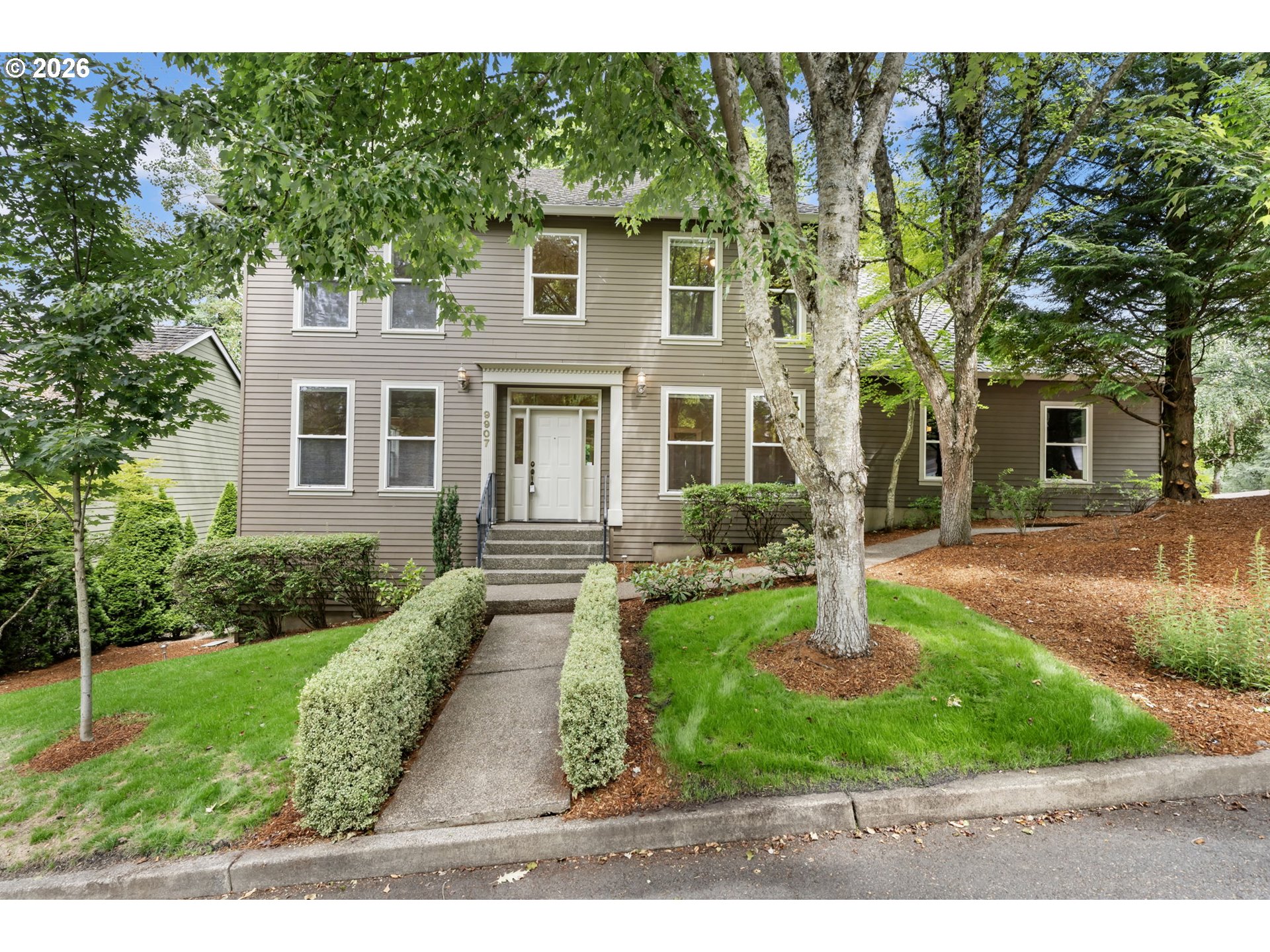 9907 Northwest Bartholomew Drive Portland, OR 97229 - Photo 2 of 37 a front view of a house with garden